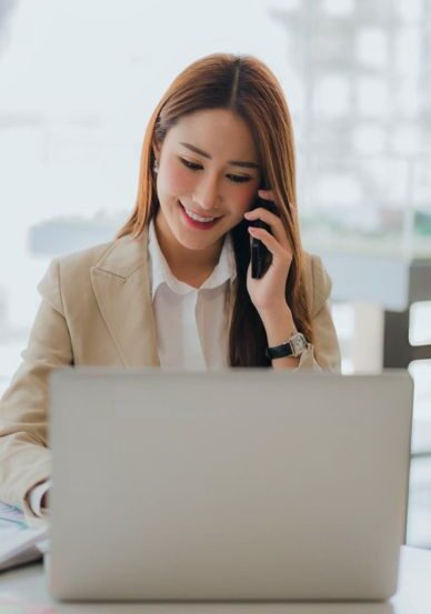 Smiling businesswoman working on laptop